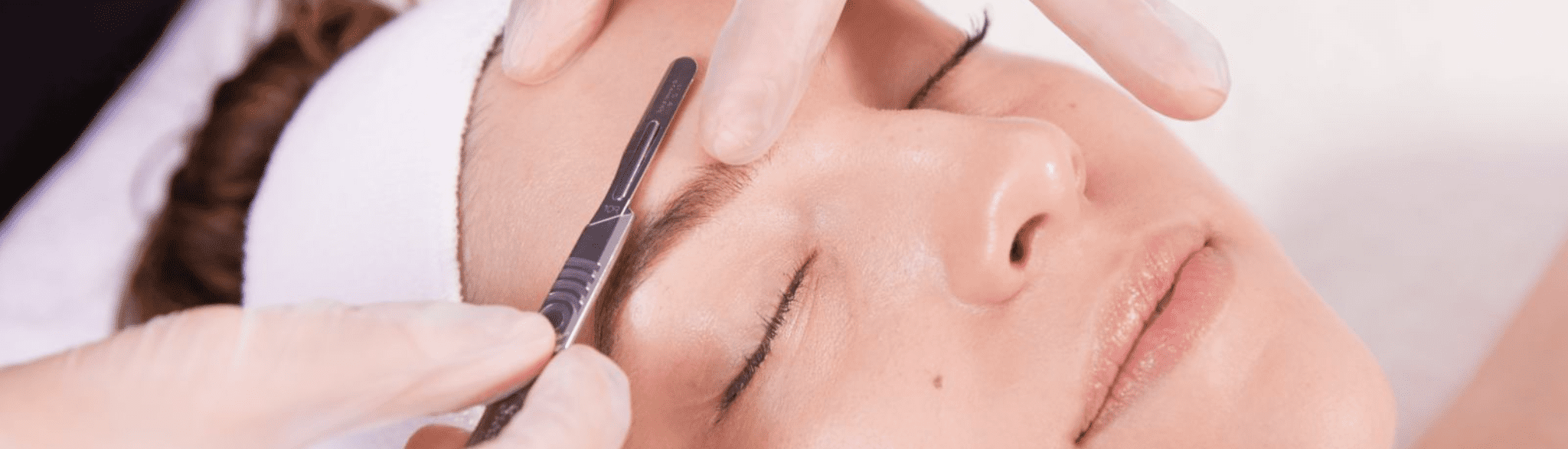 Dermaplaning being performed on woman