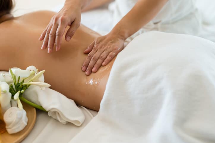 Spa Therapist performing a body treatment at a spa.