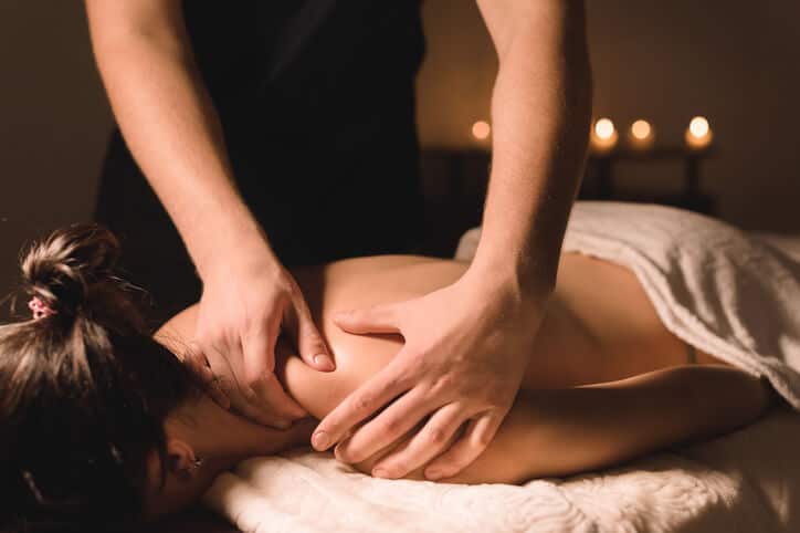 Spa Therapist performing a body treatment massage on a client.