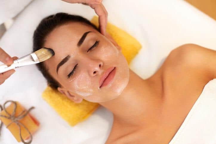 Spa Therapist applying a mask to a client at a spa
