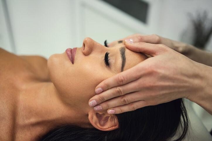 A spa therapist performing a treatment on the client.