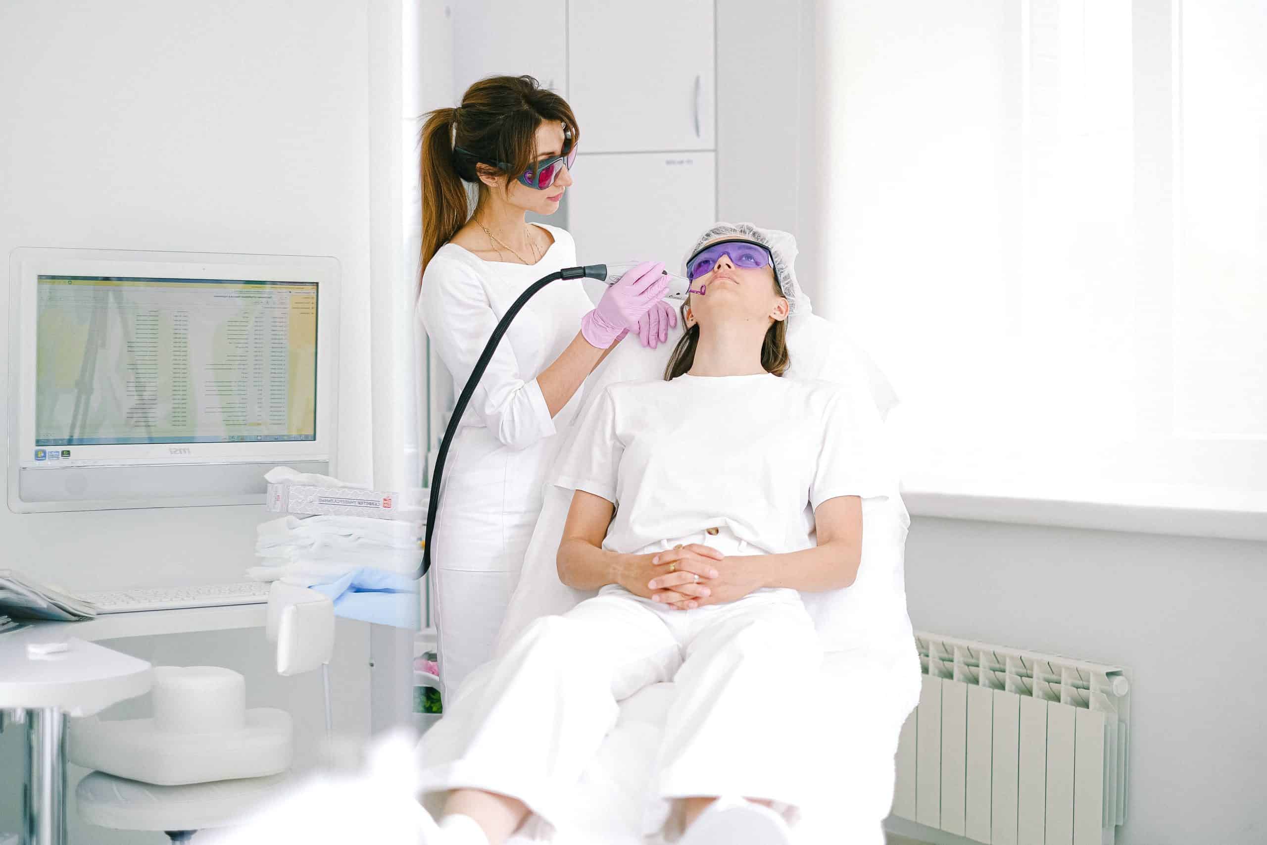 Woman receiving a photofacial treatment at a medical esthetics clinic.